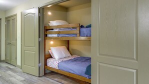 A bunk bed with two levels, a door with a handle, and a tiled floor. - Mtn Views, Pool Access! Walkable Gem Near Parkway (Pigeon Forge)