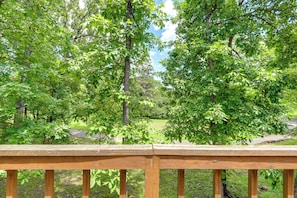 A wooden deck with a view of a park with trees and a grassy area. - Golf Getaway w/ Fairway Views Near Table Rock Lake (Eureka Springs)