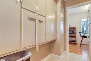 A room with beige walls, a trash bin, and a microwave on a shelf. - Close to Hospitals! Centrally Located Pueblo Condo (Pueblo)