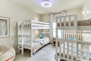 A bunk bed room with a ceiling fan, a framed picture on the wall, and a bed with a blue pillow. - Waterfront Retreat w/ Dock in Rockport! (Rockport)