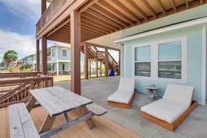 A covered outdoor area with a picnic table, two lounge chairs, and a small table with a decorative item. - Waterfront Retreat w/ Dock in Rockport! (Rockport)