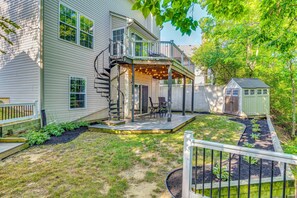 A two-story house with a covered patio, a small shed, and a fenced yard. - Treehouse Views! Walking Distance to IMS (Indianapolis)