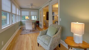 A spacious room with a large window, a ceiling fan, and a patterned armchair. - 'the Hand House!' Walk to Downtown & Race Course (Saratoga Springs)