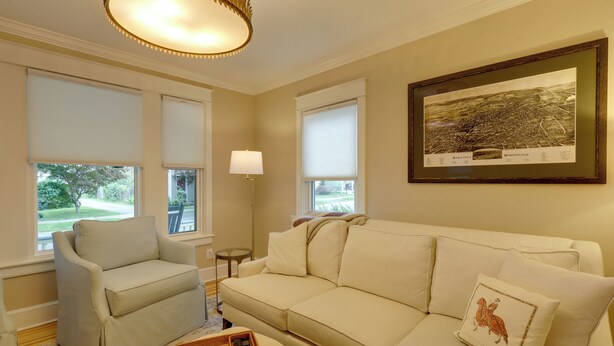 A living room with a sofa, armchair, and a framed map on the wall. - 'the Hand House!' Walk to Downtown & Race Course (Saratoga Springs)