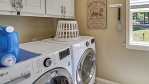A laundry room with a washing machine, a drying rack, and a window with a view of a garden. - Lakefront Gem w/ Boat Dock! 6 Mi to Hot Springs NP (Hot Springs)