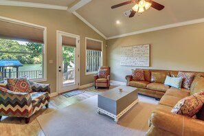 A living room with a sofa, armchairs, a coffee table, and a ceiling fan. - Lakefront Gem w/ Boat Dock! 6 Mi to Hot Springs NP (Hot Springs)