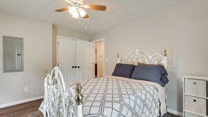 A bedroom with a bed, a ceiling fan, a dresser, and a door. - Hunt & Fish! Home < 1 Mi to Broad River Campground (Tignall)