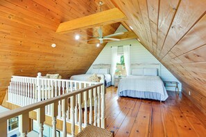 A bedroom with two beds, a wooden ceiling, and a white railing. - Fisherman's Retreat on Lake Ontario, Near Marina (Cape Vincent)