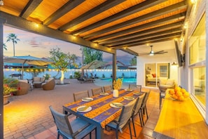 An outdoor patio with a pool, dining area, and lounge chairs. - Mesa Retreat Heated Pool Game Room Great For Families (Mesa)