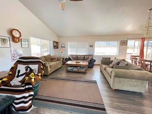 A spacious living room with a sofa set, a coffee table, and a fireplace. - Family Ranch house with Mountain View’s (Crestone)
