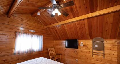 Rustic Cabin (Sleeps 2) - The Camping Cabin sleeps a maximum of 2. Bring your own linens.