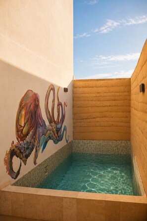 A swimming pool with a tiled floor and a wall mural. - Olivo Mío Apartment (La Paz)
