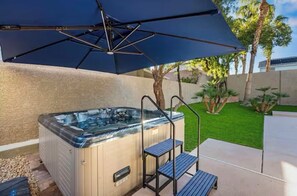 A hot tub with steps and a canopy, surrounded by a well-maintained lawn and trees. - Luxury Henderson Pool Retreat  Heated Pool  Near Las Vegas Strip (Henderson)