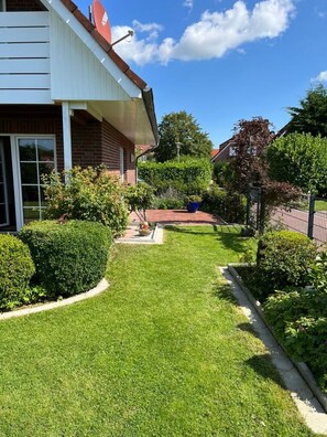 A residential property with a well-maintained lawn, a brick facade, and a satellite dish. - NEW! Achterdeck Vacation Home (Hooksiel)
