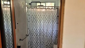 A bathroom with a toilet, sink, and shower curtain. - Cabinas Playa Surf Hostel (Cobano)