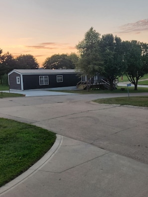 A single-story building with a flat roof, a covered porch, and a driveway leading to the entrance.