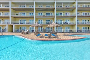 Dive into crystal-clear waters surrounded by tropical thatched umbrellas and comfortable loungers—your perfect poolside paradise awaits. - Coastal Retreat with Pool & Beach Access (Port Aransas)