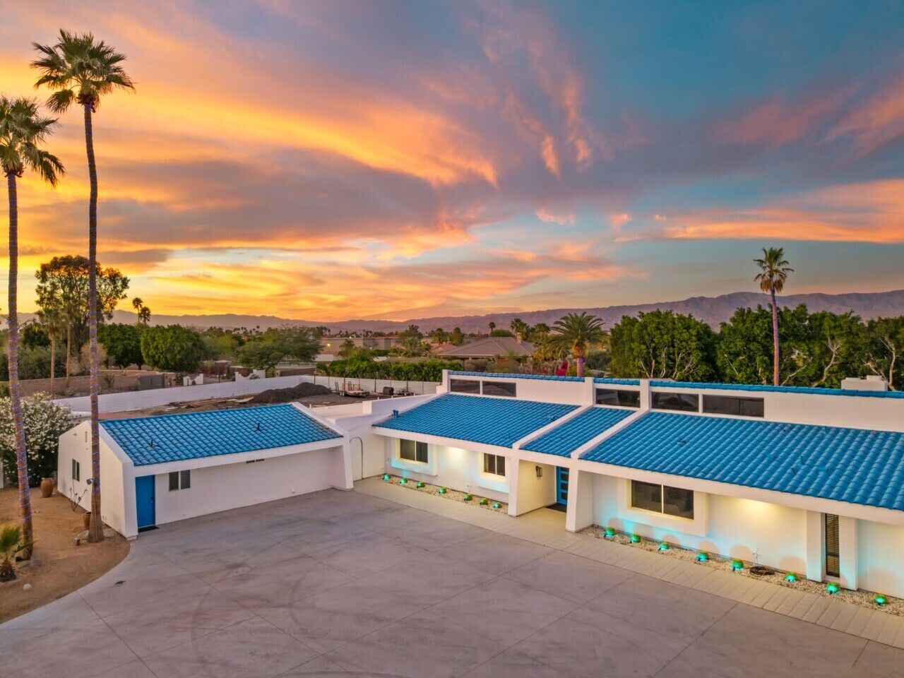 A modern building with multiple rooms, a flat roof, and a clear view of the surrounding landscape.