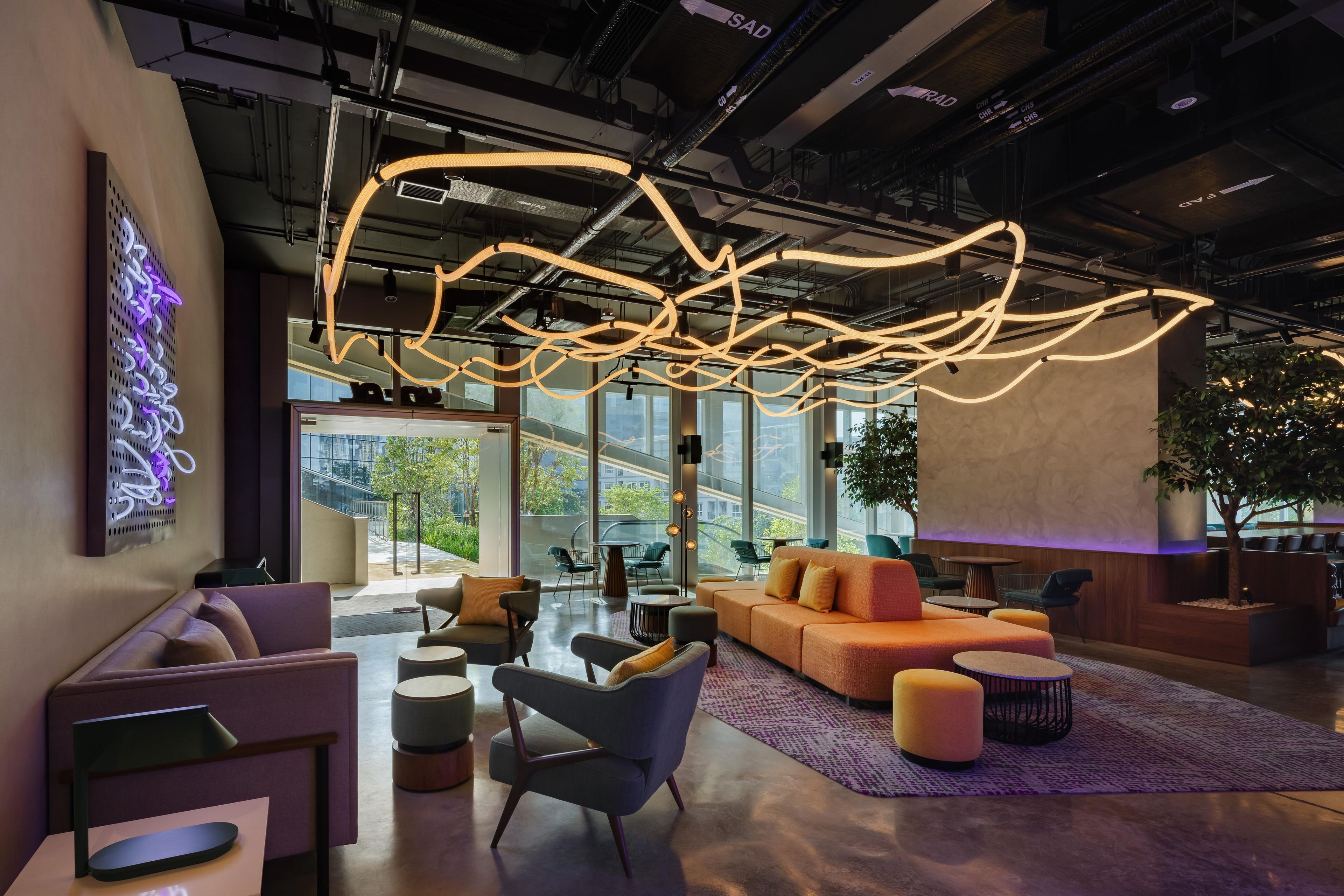 A modern interior with a lounge area featuring sofas, chairs, and a coffee table.