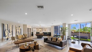 A spacious living area with a pool table, comfortable seating, and large windows offering a view of the outdoors. - Sleek Miami 2BR - Free parking - Pool (Miami)