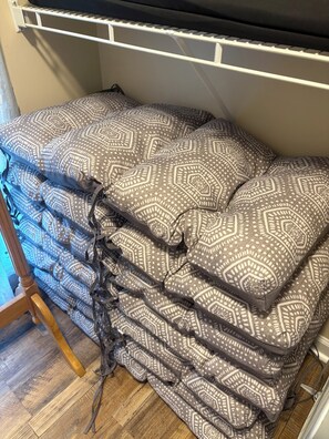A bed with patterned bedding and a wooden headboard.