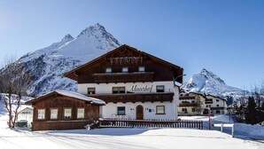A two-story building with a sign reading 'Maashof' in a snowy mountain setting. - Maashof (Galtür)