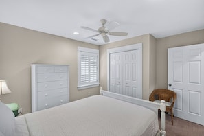 A bedroom with a bed, a dresser, a ceiling fan, and a chair. - Waterfront & Sunset Views!!  3-bedroom house on Albemarle Sound (Kill Devil Hills)