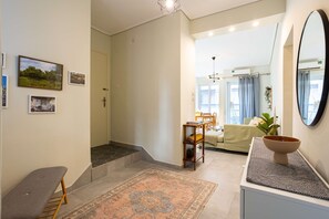 A modern living room with a sofa, a coffee table, and a rug. - Seaside Retreat for Relaxed Kalamata Beach Stays (Kalamata)