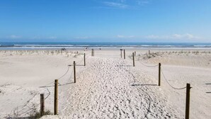 A sandy beach with a clear sky and ocean in the background. - Sun&Sand Oasis - Beach Front - 2/2 Condo - Next to Heated Pool - Ground Floor (St. Augustine)