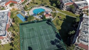 An aerial view of a residential area with a tennis court, a swimming pool, and surrounding buildings. - Sun&Sand Oasis - Beach Front - 2/2 Condo - Next to Heated Pool - Ground Floor (St. Augustine)