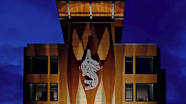 A modern building with a unique wooden facade and a central carved design. - The Point Casino and Hotel (Kingston)