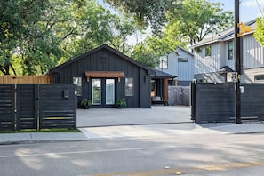 A residential property with a garage, a covered entryway, and a fenced driveway. - Onyx & Oak - Hot Tub & Backyard Oasis, East Austin (Austin)