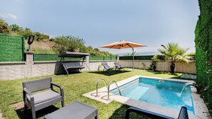 A backyard with a swimming pool, lounge chairs, a table, and an umbrella. - 4-deluxe Villa With Heated Private Pool (Dilovasi)