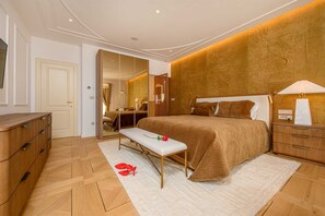 A bedroom with a large bed, a bench, a dresser, and a nightstand. - Beachfront Villa Adriatic Z with Pool (Žaborić)