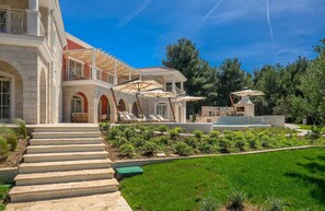 A large house with a pool, outdoor seating, and a well-maintained garden. - Beachfront Villa Adriatic Z with Pool (Žaborić)