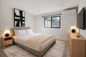 A modern bedroom with a large bed, bedside tables, a TV, and a window with a view. - Private 1Bd/1B Near Studios, Universal & Hollywood (Los Angeles County)