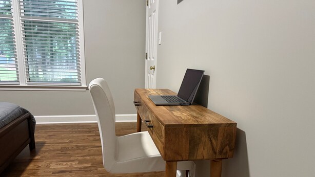 A room with a wooden desk, a laptop, a white chair, and a bed. - NEW LISTING Lake View In Reynolds on Oconee, 2bd/2bath Fully Remodeled Sleeps 6 (Greensboro)