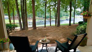 A patio with two chairs and a table, overlooking a lake and a golf course. - NEW LISTING Lake View In Reynolds on Oconee, 2bd/2bath Fully Remodeled Sleeps 6 (Greensboro)