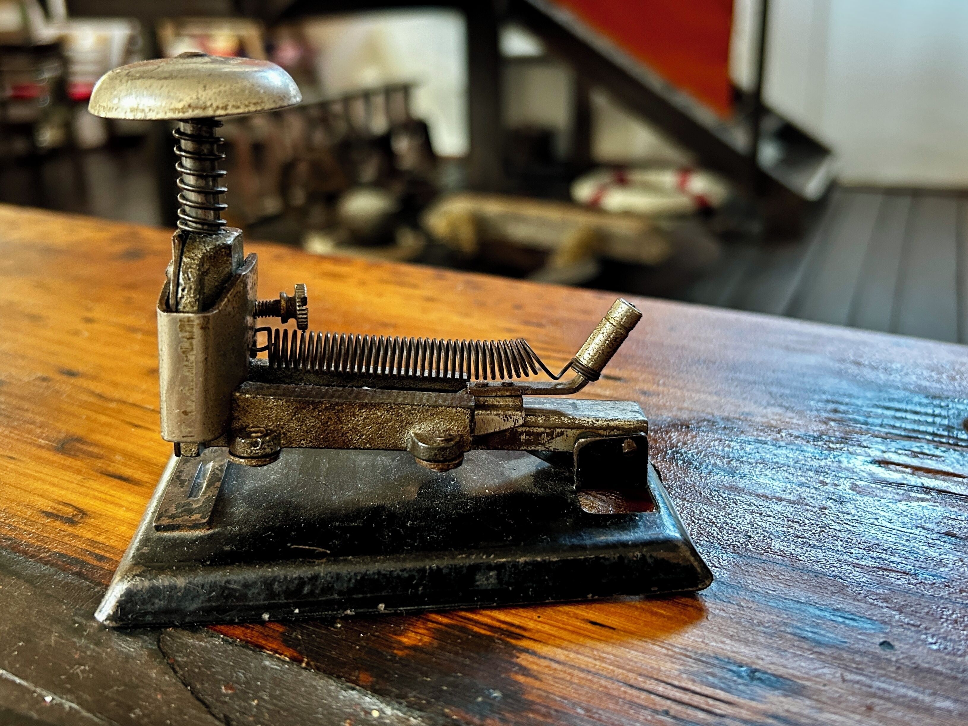 A vintage mechanical device on a wooden surface.
