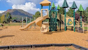 A playground with a slide, climbing structures, and a covered area. - Hermosa Meadows Hideaway - 360° Red Cliff Views, Sleeps 5, 10 min to Durango (Durango)