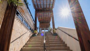 A staircase leading up to a wooden pergola with a clear sky above. - Gorgeous Intracoastal - 2BR Upper Beachwalk Suite (Hallandale Beach)