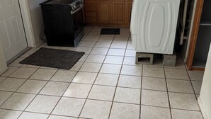 A compact kitchen with a refrigerator, oven, microwave, and wooden cabinets. - 3/2:  Walk to River's Edge, Downtown Melbourne, and a hop over to the beach. (Melbourne)