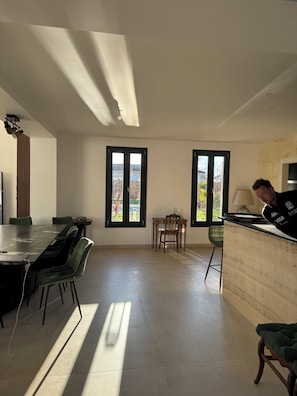 A modern interior with a dining area, a bar, and large windows. - ⭐ Villa Aetheria: Large Pool, Movie Theater—An Exceptional Villa Near Bordeaux (Ambarès-et-Lagrave)