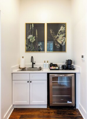 Chic coffee bar with mini fridge, sink, and elegant botanical artwork - Attractive 1-Bed, 1-Bath Downtown Studio Apt. (Columbia)