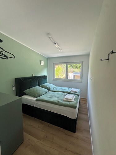 Private wellness lodge by the lake, with air conditioning, a heated pool, a hot tub, and a sauna