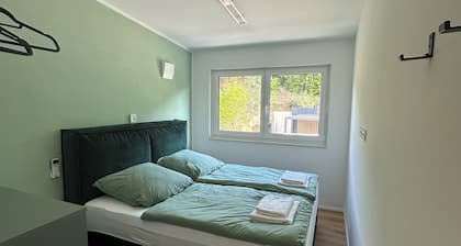 Private wellness lodge by the lake, with air conditioning, a heated pool, a hot tub, and a sauna