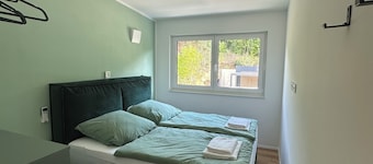 Private wellness lodge by the lake, with air conditioning, a heated pool, a hot tub, and a sauna