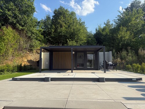 Private wellness lodge on Lake E with air conditioning, a pool, a hot tub, and a sauna