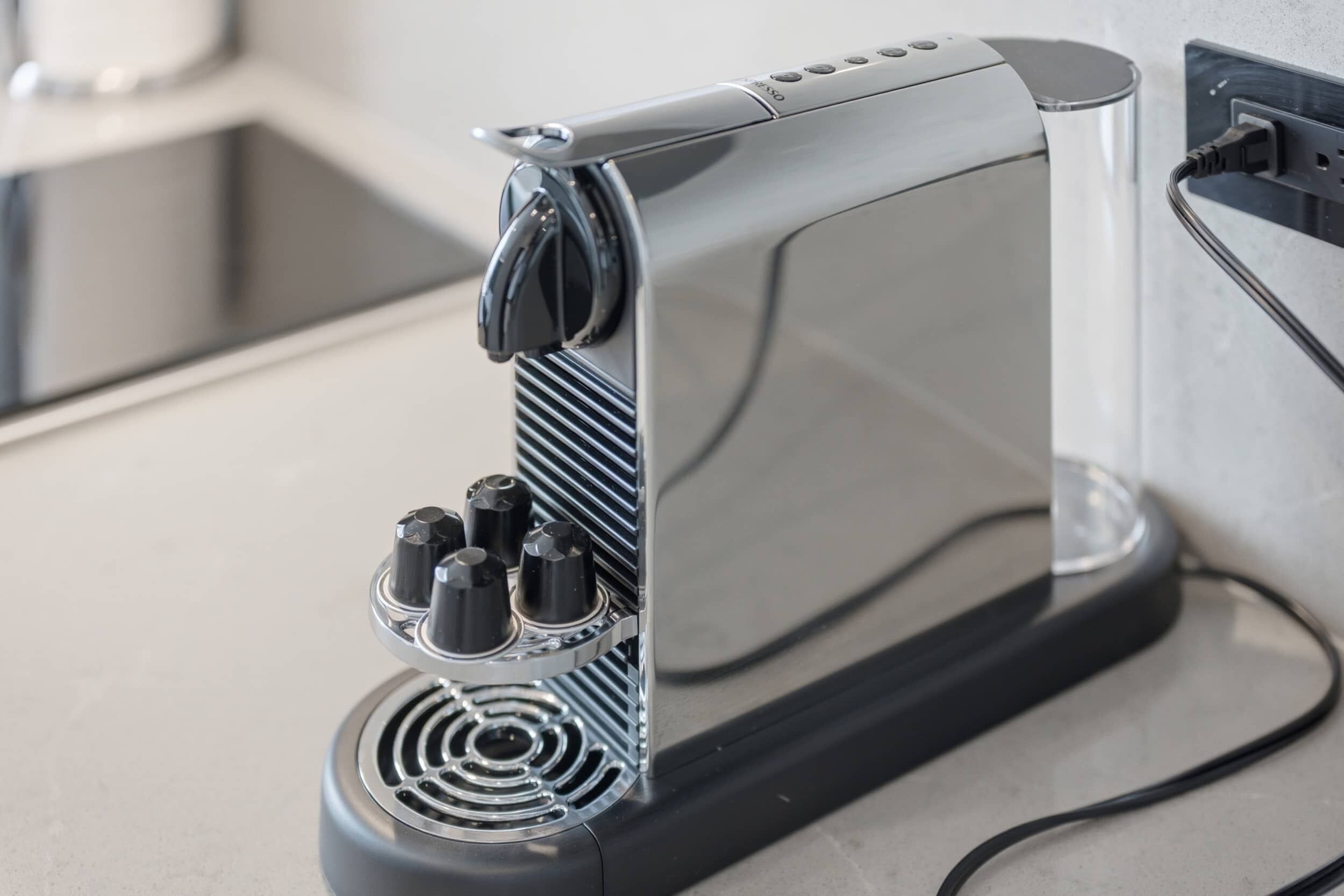 A kitchen appliance with a control panel, a power cord, and a vent.