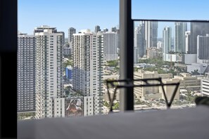 A high-rise building with a clear view of the cityscape through a window. - Experience The Brand New E11EVEN Residences (Miami)